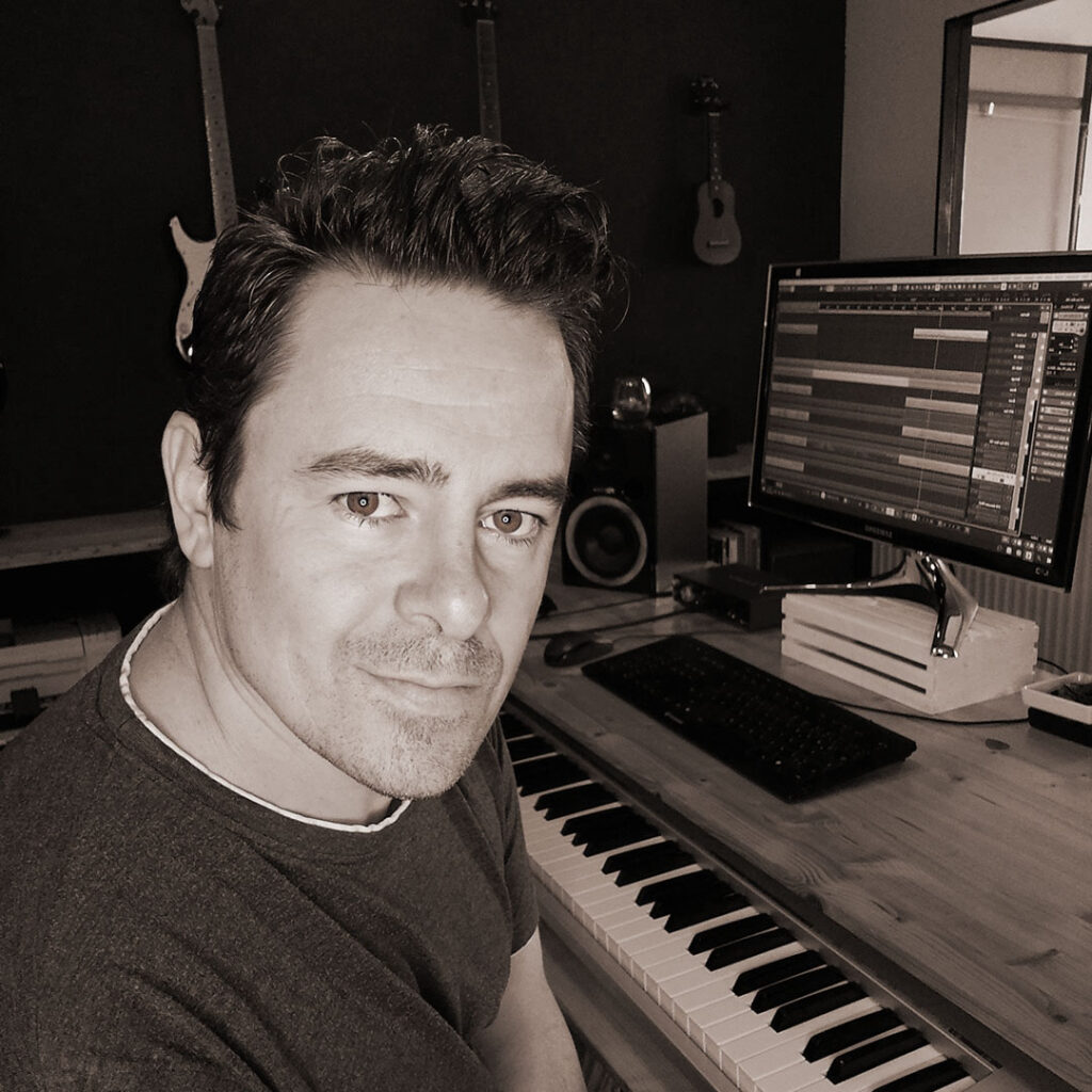 Michael Wolf songwriter and composer working in his music studio in Lower Austria